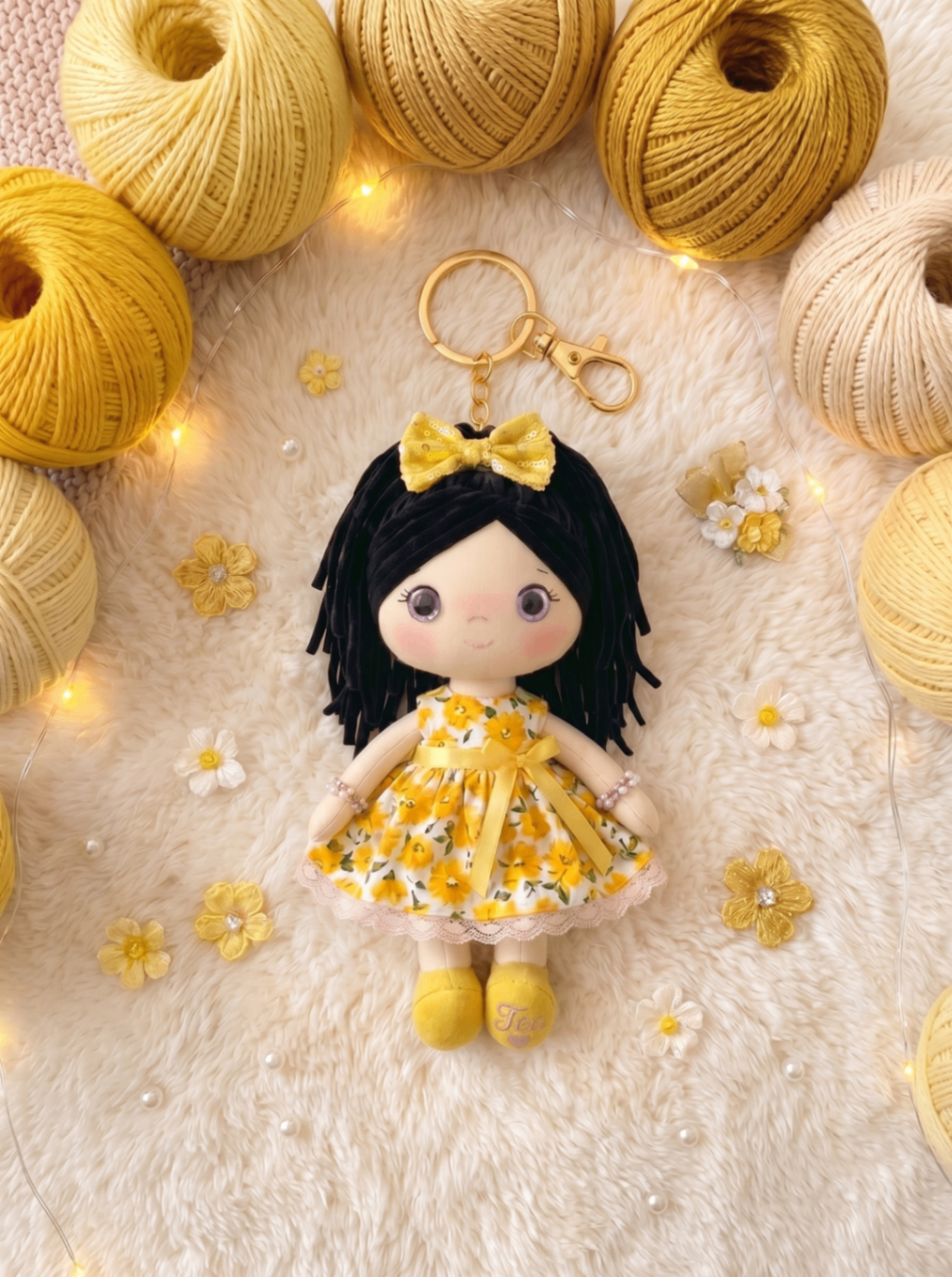 Sunshine keychain with gold hardware and personalization on the sole.